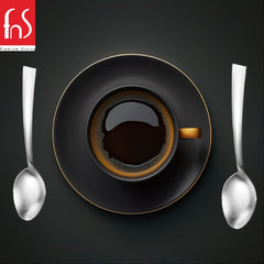 FNS Premium Dining Casper coffee spoons with satin matte finish displayed beside black espresso cup with gold rim on matching saucer against dark textured background