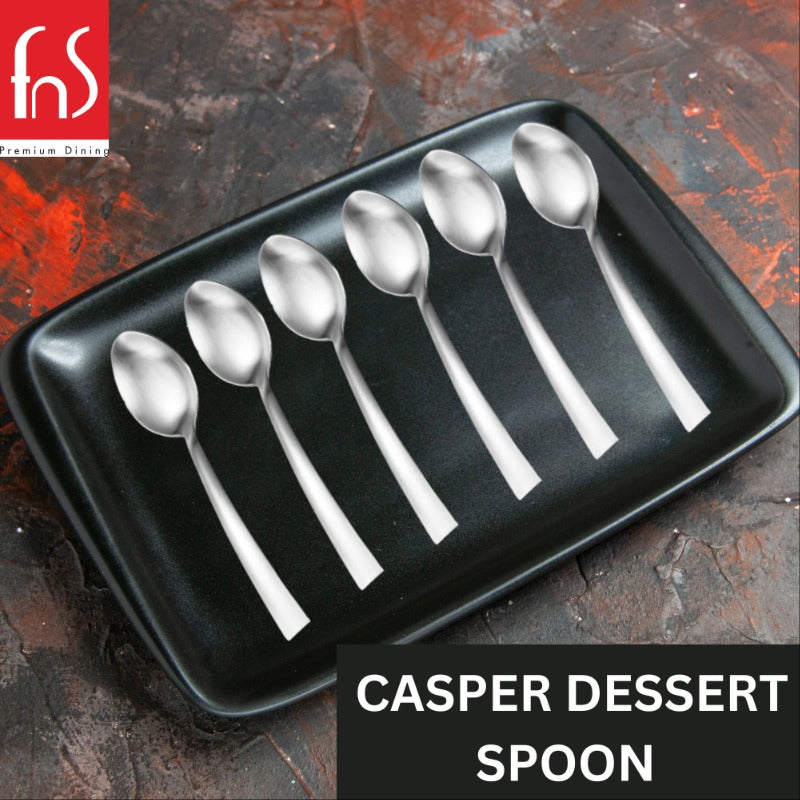 FNS Premium Dining Casper 6-piece dessert spoons with satin matte finish arranged on black rectangular tray against rustic orange and gray distressed surface