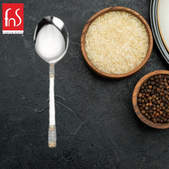 FNS Celebration gold plated serving spoon lifestyle shot on dark slate with wooden bowls filled with white rice and black peppercorns