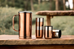 Single two-tone stainless steel tumbler with silver upper band and rose gold lower body, showing brushed finish and dark mirror interior, on white background.