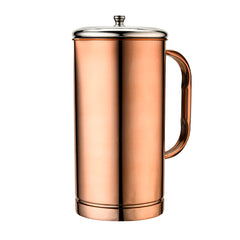 Close-up of a two-tone stainless steel tumbler with silver upper band and brushed rose gold lower body, placed on a table with orange juice and bottles in background.