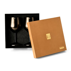 FNS Premium Dining set of 2 black stainless steel wine glasses displayed in an open gold and black foam-lined gift box on white background