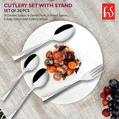 Elegant stainless steel cutlery displayed around a white plate with colorful salad on textured tablecloth.