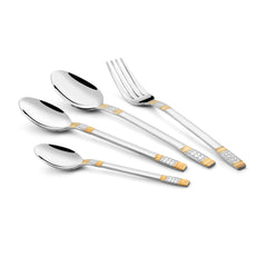 Angled view of four polished utensils featuring gold and silver etched patterns on white background.