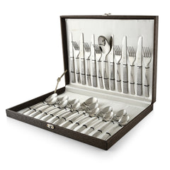 Elegant silver cutlery set with textured handles neatly arranged inside an open brown gift box case.