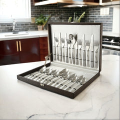 Premium hammered-handle cutlery set displayed open in a brown gift box on a modern kitchen counter.