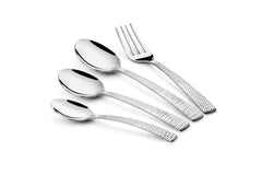 Elegant hammered-handle cutlery set laid diagonally on white background, featuring spoons and a dinner fork.