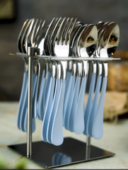Glossy silver cutlery set with matte light blue handles neatly arranged in a square vertical stand.