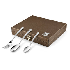 Closed gift box with textured fork and spoons neatly placed on top to showcase the design.