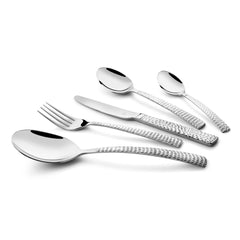 Stainless steel fork, knife, and spoons with hammered handles displayed diagonally on white background.