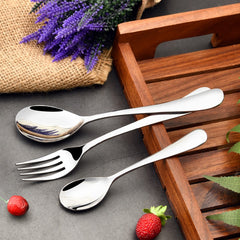 Elegant fork and spoons placed beside wooden tray and lavender, with strawberries on a dark surface.