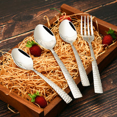 Hammered-handle fork and spoons beautifully arranged in a wooden tray with hay and strawberries decor.
