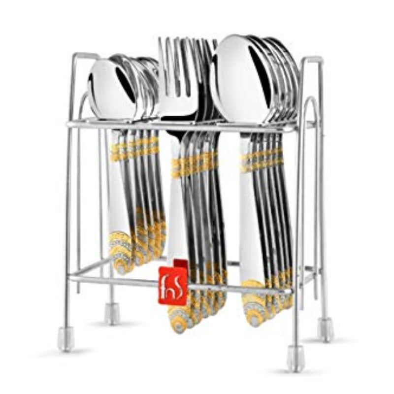 Stainless steel cutlery set with ornate gold detailing neatly arranged in a vertical metal stand.