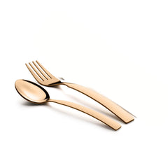 Sleek gold fork and spoon placed diagonally on a clean, bright white surface.