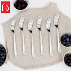 Six forks on beige linen with bowls of fresh berries