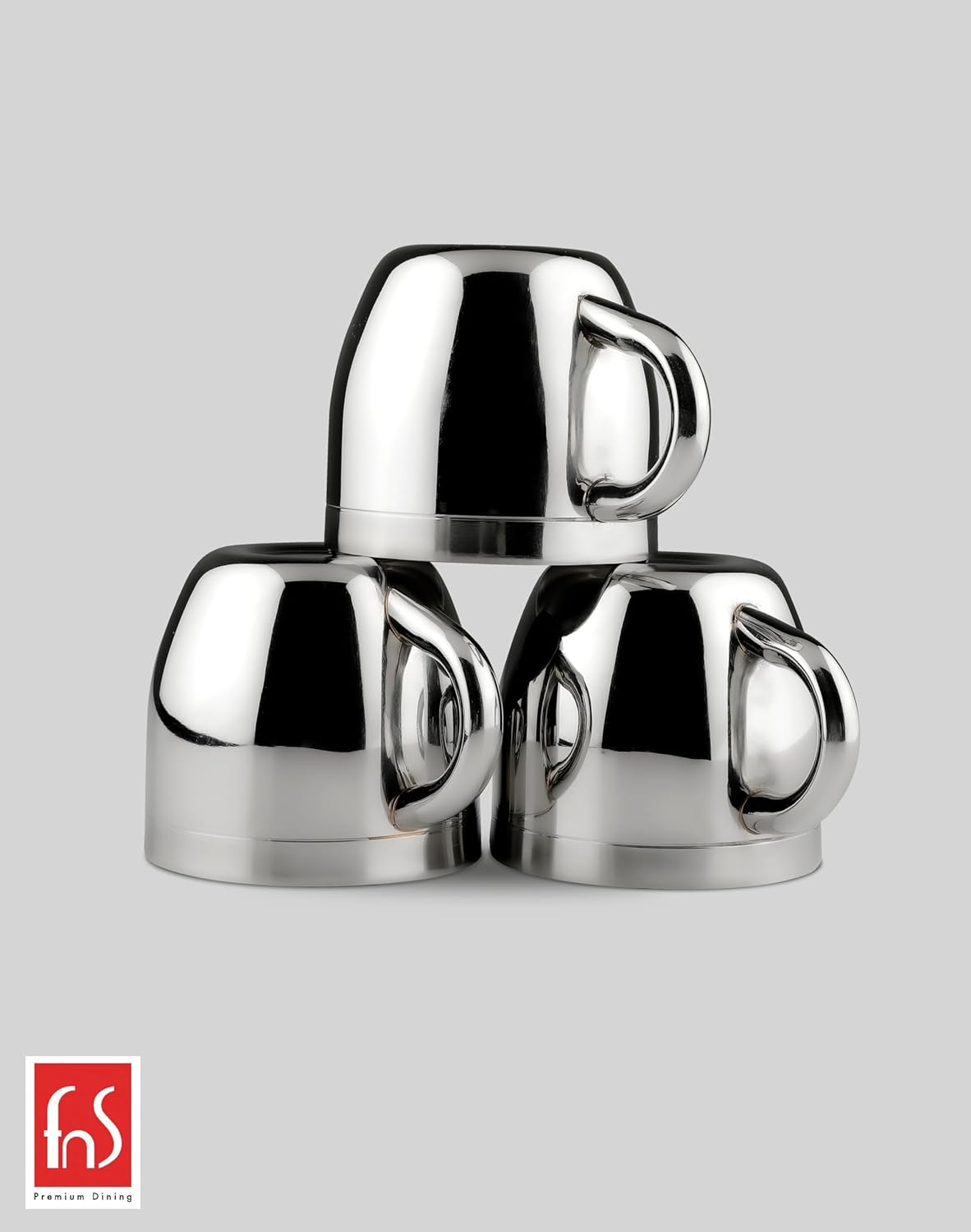 Three fns double wall stainless steel tea cups with mirror finish stacked together in pyramid arrangement on grey background
