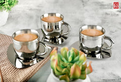 Three fns double wall stainless steel cups on triangular saucers filled with coffee, styled on grey marble surface with succulent plants and woven mat