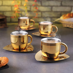 Set of 4 fns gold finish stainless steel tea cups with matching square saucers and polished silver interior, arranged together on white background