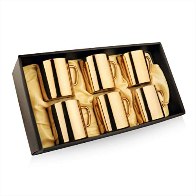 Angled view of set of 6 FNS Premium Dining gold mirror finish stainless steel coffee mugs arranged in an open black luxury gift box with gold satin lining on white background