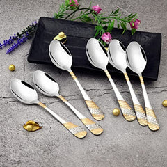 FNS Imperio 6 piece dinner spoon set with 24 karat gold plated textured handles displayed on black tray with fresh flowers