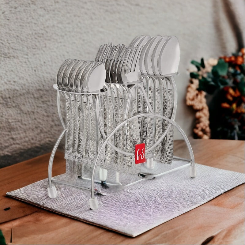 Textured stainless steel cutlery set organized neatly in a stylish silver stand on a wooden table.