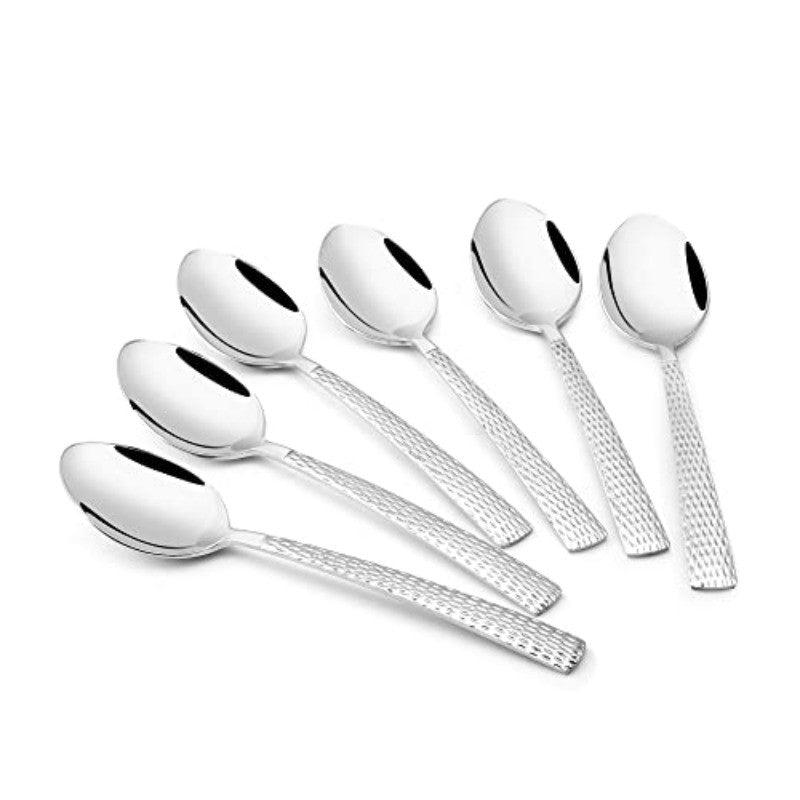 Six stainless steel spoons arranged in an overlapping fan pattern on white background, displaying the textured diamond-pattern handles and polished bowls
