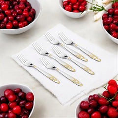 Six stainless steel dinner forks with gold decorative handles surrounded by cranberry bowls