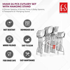 Four polished stainless steel utensils arranged on dark surface showing elegant design and craftsmanship quality