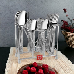 Stainless steel cutlery set with textured handles neatly arranged in stand, placed beside cherries in bowl.