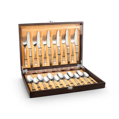 Opened luxury dark wooden display case with leatherette box containing complete Navia cutlery set with silver utensils and textured handles arranged in cushioned compartments.
