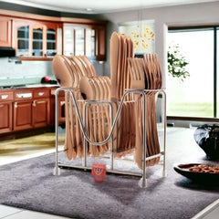 Full rose gold cutlery set in sleek metal stand placed on kitchen counter with modern background.