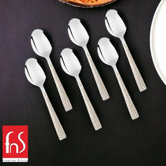 FNS Premium Dining 6-piece stainless steel dessert spoons with pearl-textured handles and mirror-polished bowls displayed on black slate surface with white plate