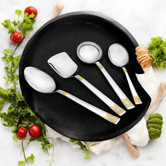 FNS Raga 4-piece serving set with 24-karat gold plated accents on black plate with fresh tomatoes, herbs, and vegetables lifestyle setting