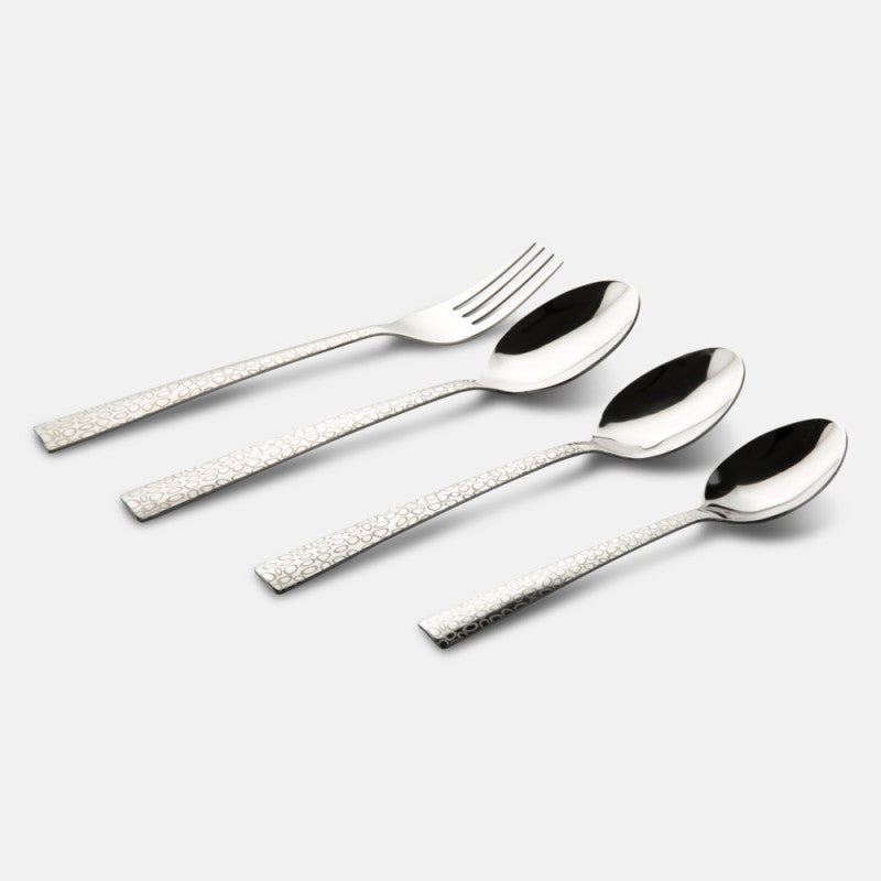 Fork and three spoons with elegant embossed handles arranged diagonally on a minimal grey background.