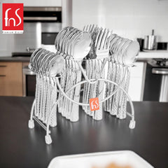 Shiny cutlery set with geometric handles in hanging stand displayed on black countertop in modern kitchen.