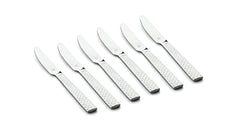 Six mirror-finished dinner knives featuring stylish textured handles laid out on a plain surface.
