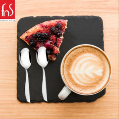 FnS Premium Dining flatware styled with berry tart and latte coffee on black slate, showcasing elegant stainless steel spoons for dessert and beverage service.
