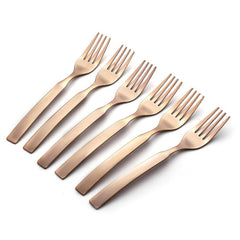 Six copper-colored forks scattered at angles on white backgroundRetry