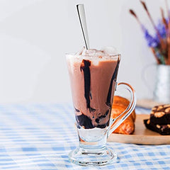 FNS Slim Line long drink spoon in chocolate milkshake glass with ice cream topping, ideal for tall beverages, smoothies, and dessert drinks.