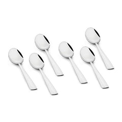 Six mirror-polished stainless steel teaspoons with angled flat handles arranged in scattered formation on white background showing modern minimalist design