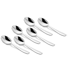 Six shiny silver tablespoons arranged evenly in two rows on a clean white surface background