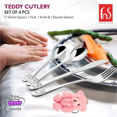 Children’s cutlery set with engraved teddy bears placed beside a meal plate and toddler’s hands.