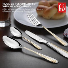 Close-up of Tivoli gold-accented fork, knife, and spoons placed on elegant dining setup.