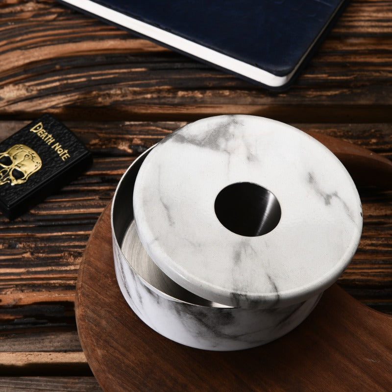 FNS white marble finish ashtray with removable lid on wooden cutting board with Death Note book and tablet