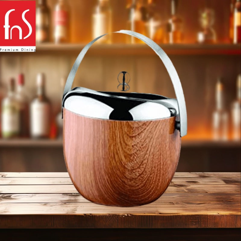 FNS wooden finish apple-shaped ice bucket with chrome lid and arched handle on rustic bar counter with bottle display background