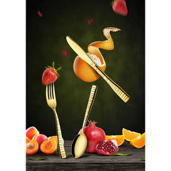 Stylish gold FNS cutlery set with knife, fork, and spoon surrounded by fruits on dark backdrop.