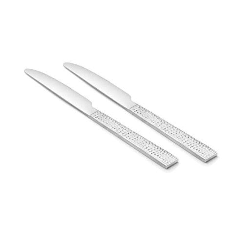 Pair of FnS Helios stainless steel dinner knives with distinctive perforated rectangular handles arranged diagonally on white background.