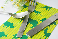 Spoon, fork, and knife featuring monkey and elephant engravings on jungle-printed napkin background.