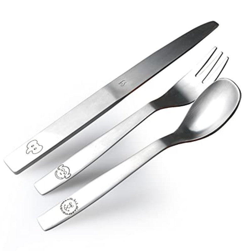 Stainless steel kids’ cutlery set with playful animal engravings, positioned neatly on white backdrop.