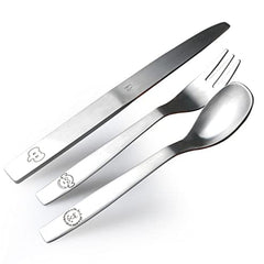 Stainless steel kids’ cutlery set with playful animal engravings, positioned neatly on white backdrop.